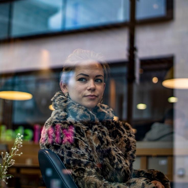 Avery Chen, Lead Design Curator at QuillHarborMeadow, reviewing corporate floral arrangements